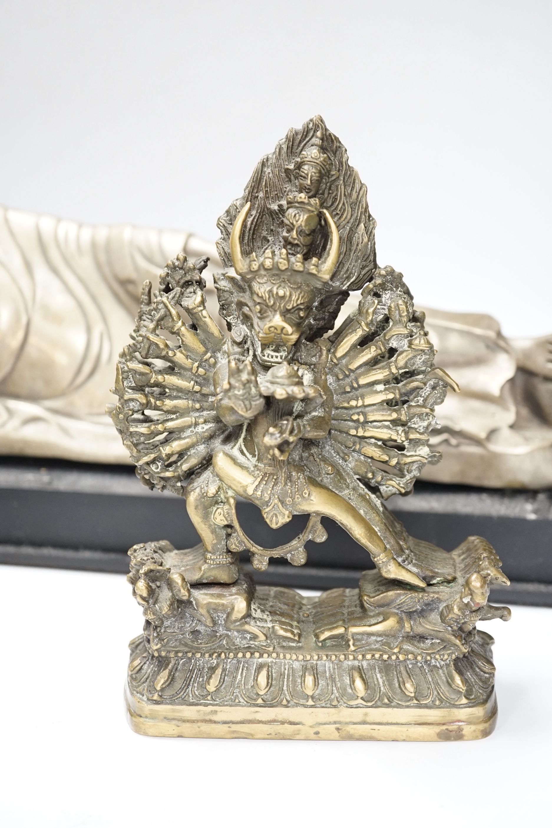 Three bronze and other metal figures of the Buddha and a Tibetan figure of Yamantaka, tallest 21.5cm